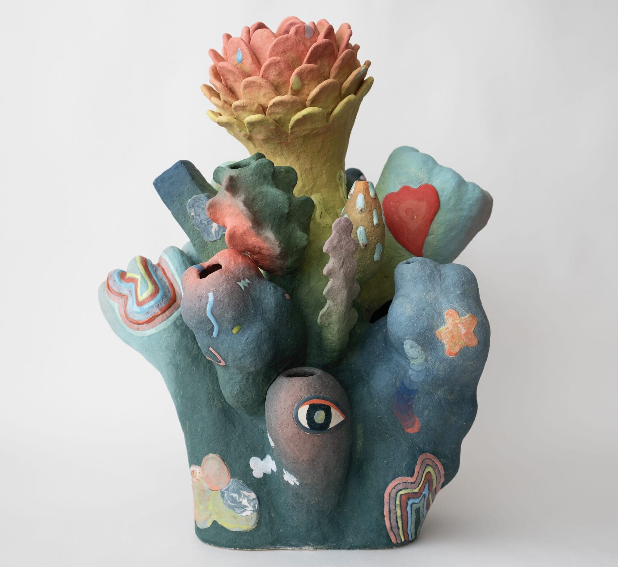 an abstract, colorful ceramic sculpture with nature-inspired elements evocative of coral or flowers