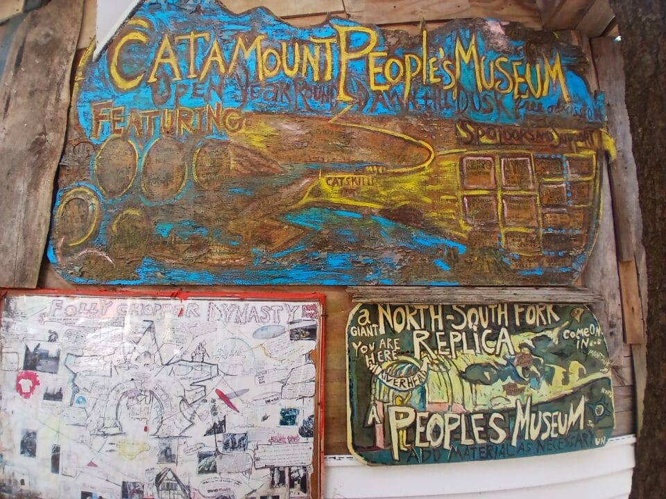 a collection of hand-painted signs that read "Catamount People's Museum"