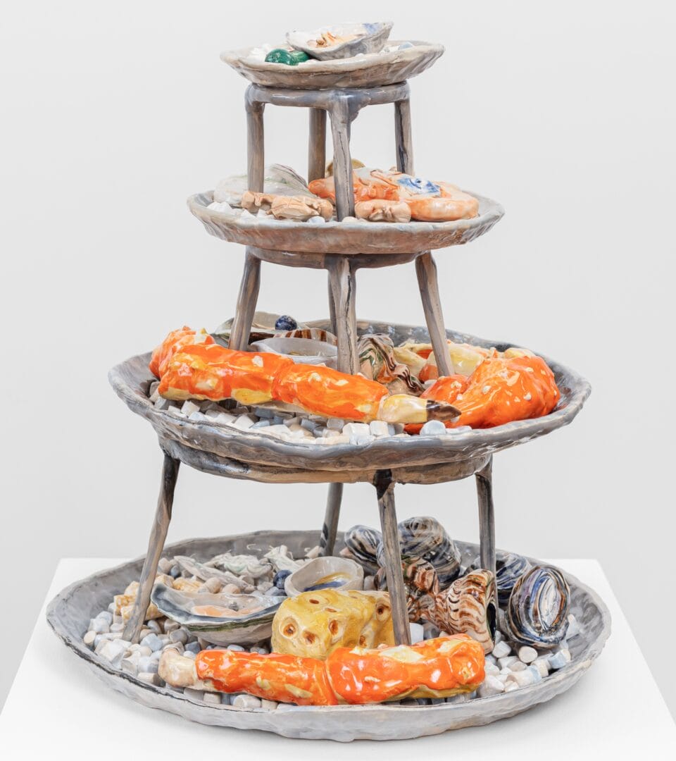 a seafood tower with lobster, oysters and shrimp