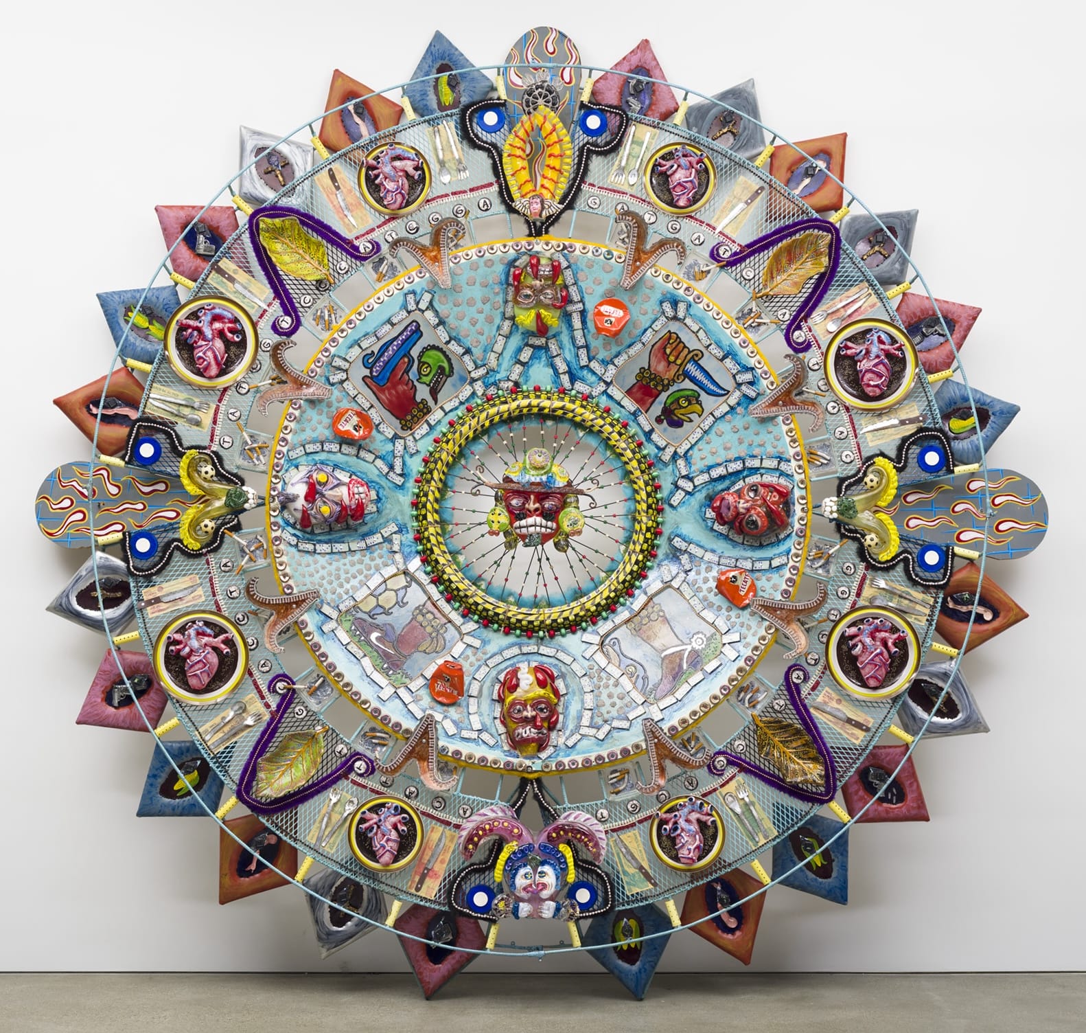 an abstract glass sculpture in the form of an Aztec calendar with numerous mixed-media details and patterns