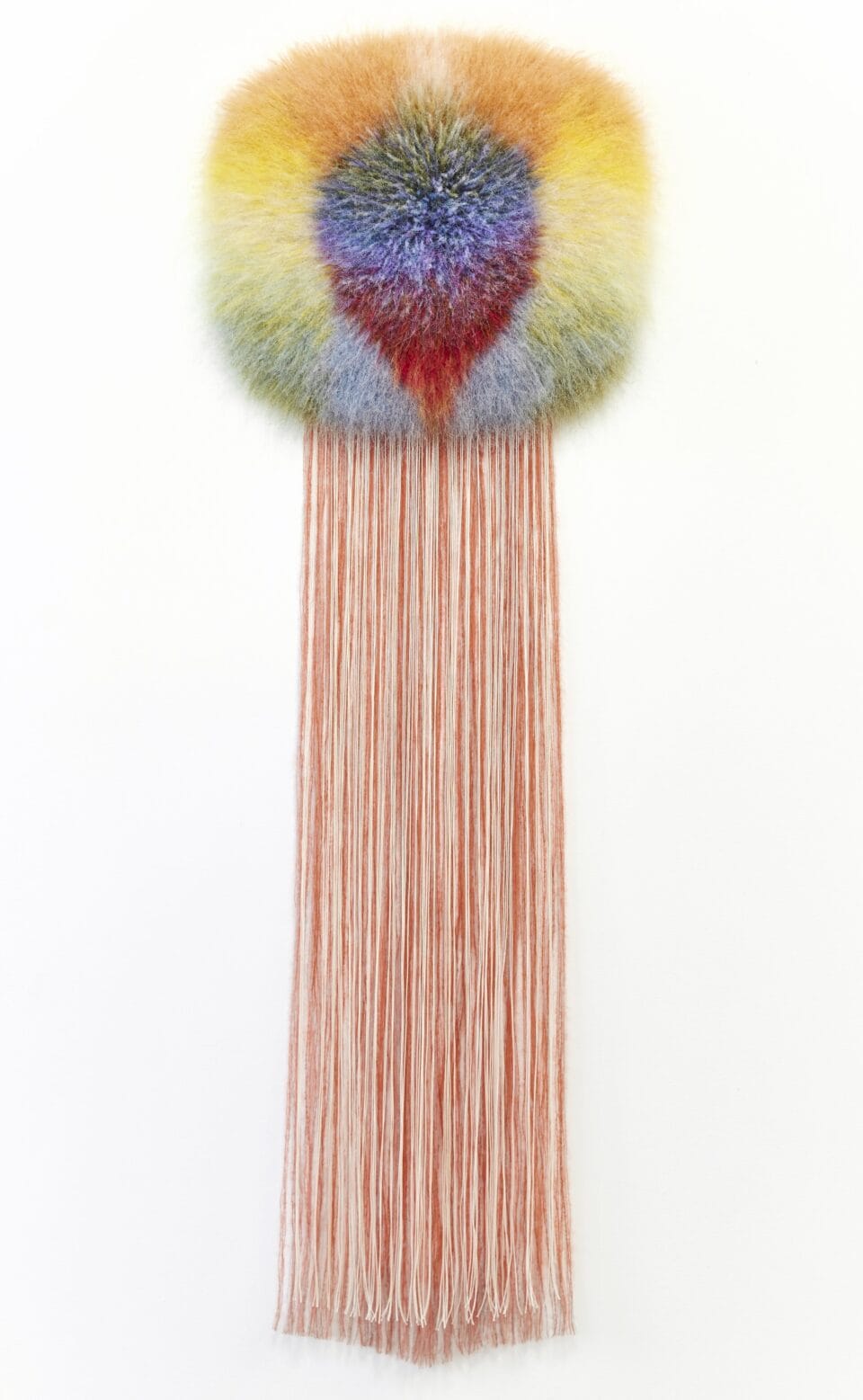 an abstract, bright weaving radiating fiber in other colors into a puffy form, with orange fiber draping long at the bottom