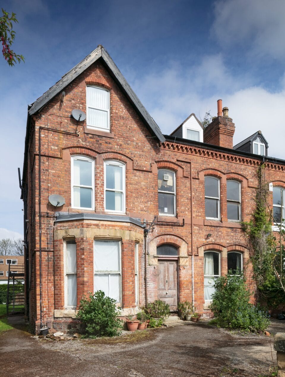 the exterior of Ron Gittins' flat in Birkenhead, England, with a brick facade and gable roof