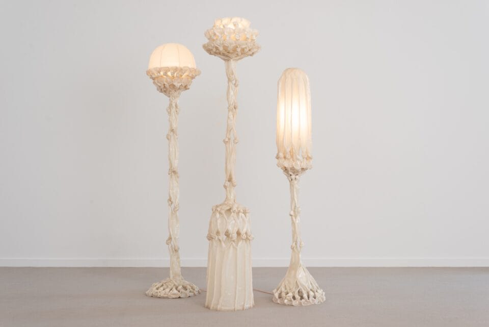 a group of three sculptural white lamps made from pieces of fabric coated in bio resin and knotted