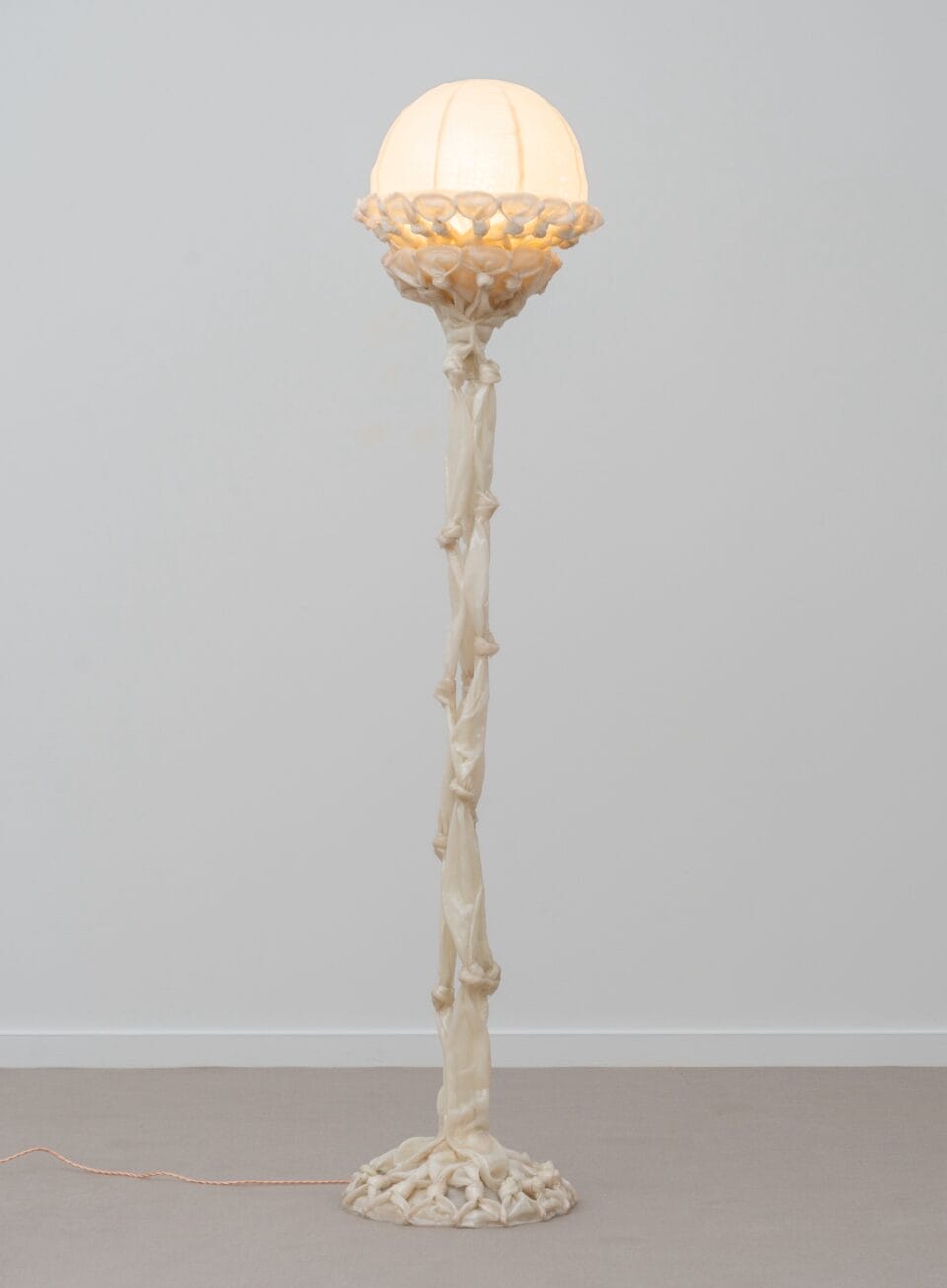 a sculptural white lamp made from pieces of fabric coated in bio resin and knotted