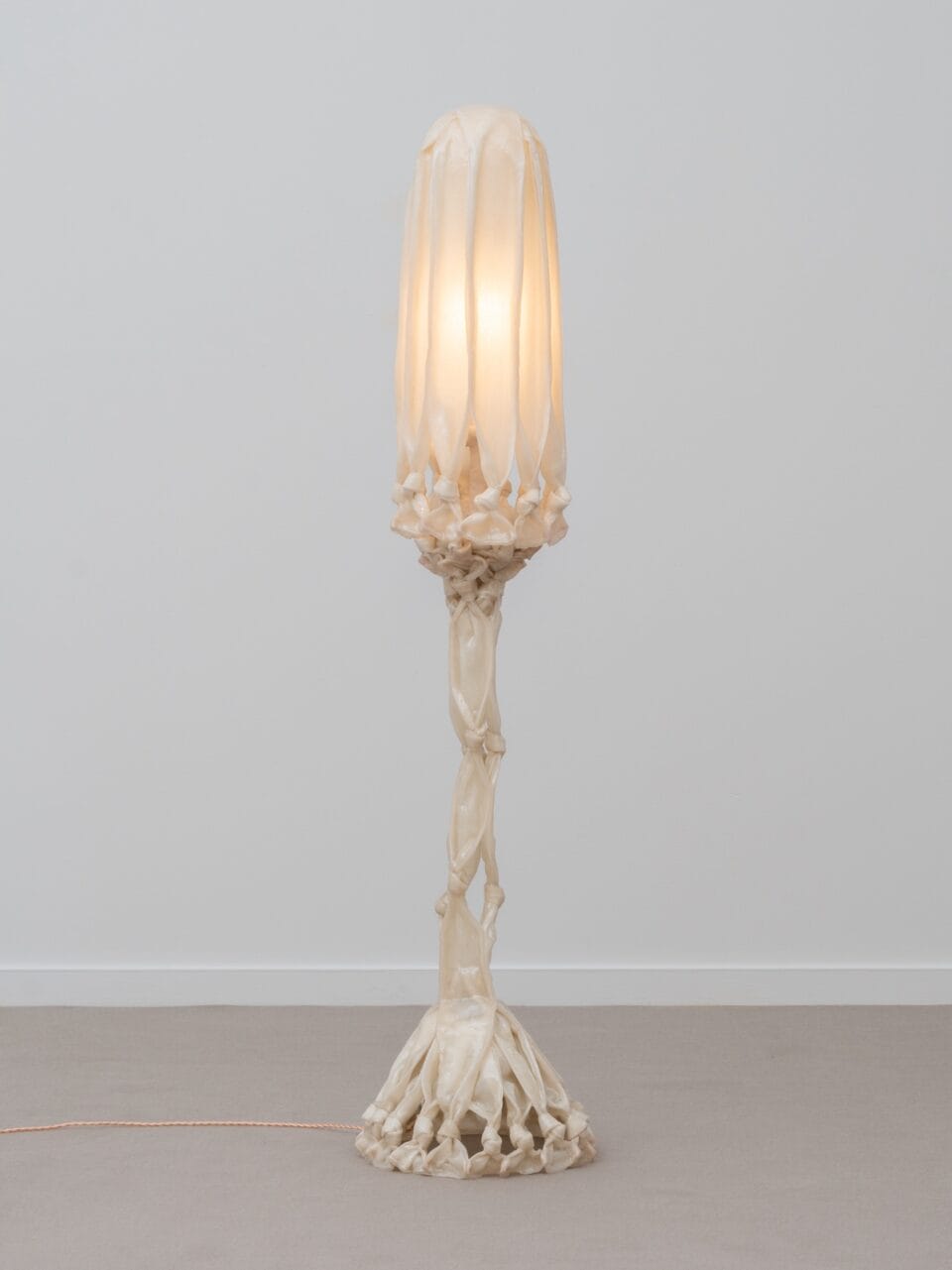 a sculptural white lamp made from pieces of fabric coated in bio resin and knotted