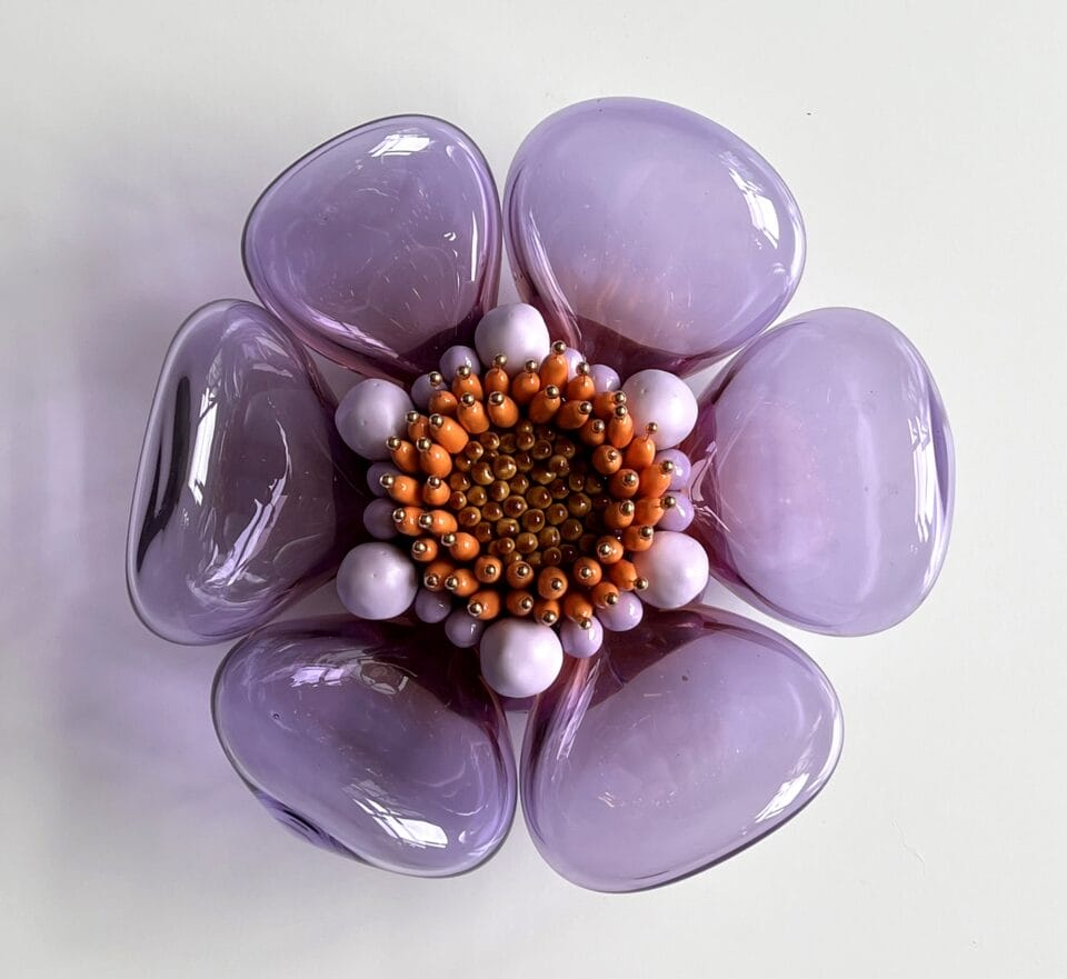 a botanical sculpture of a flower, made from glass, wood, and ceramics