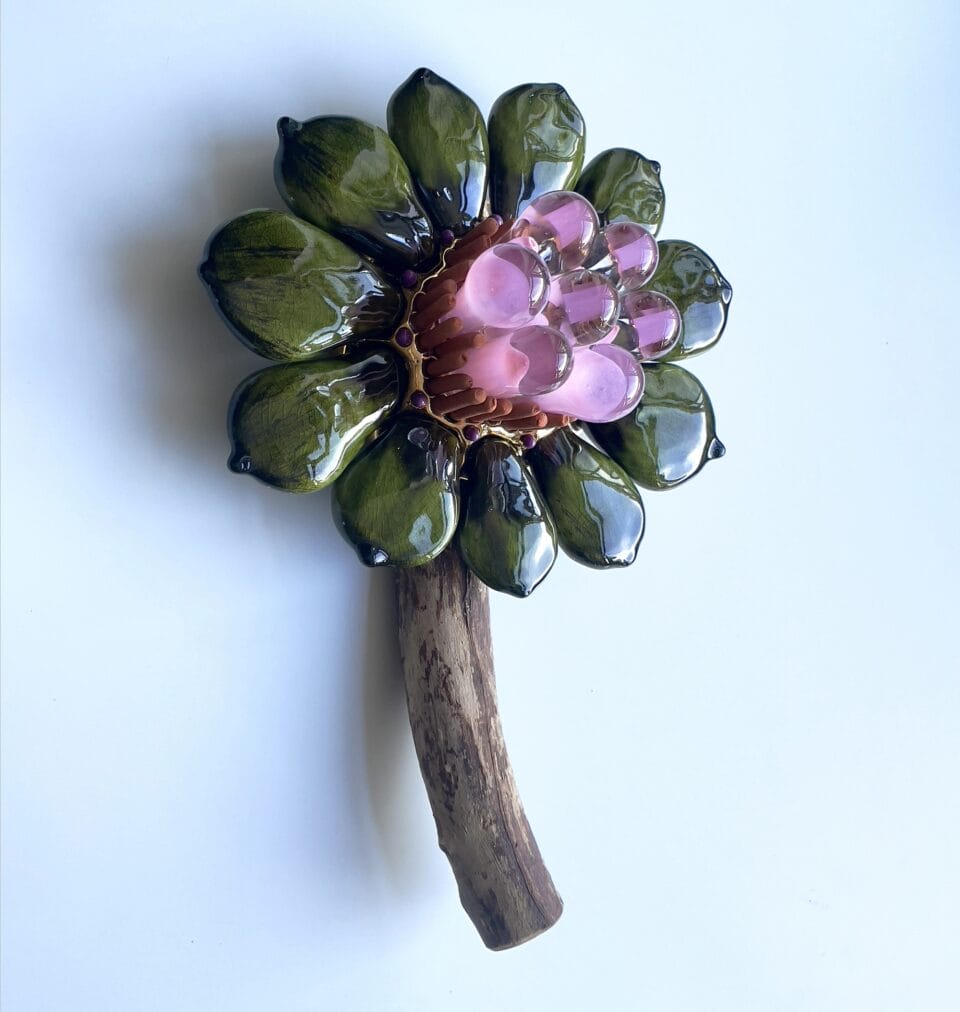 a botanical sculpture of a flower, made from glass, wood, and ceramics