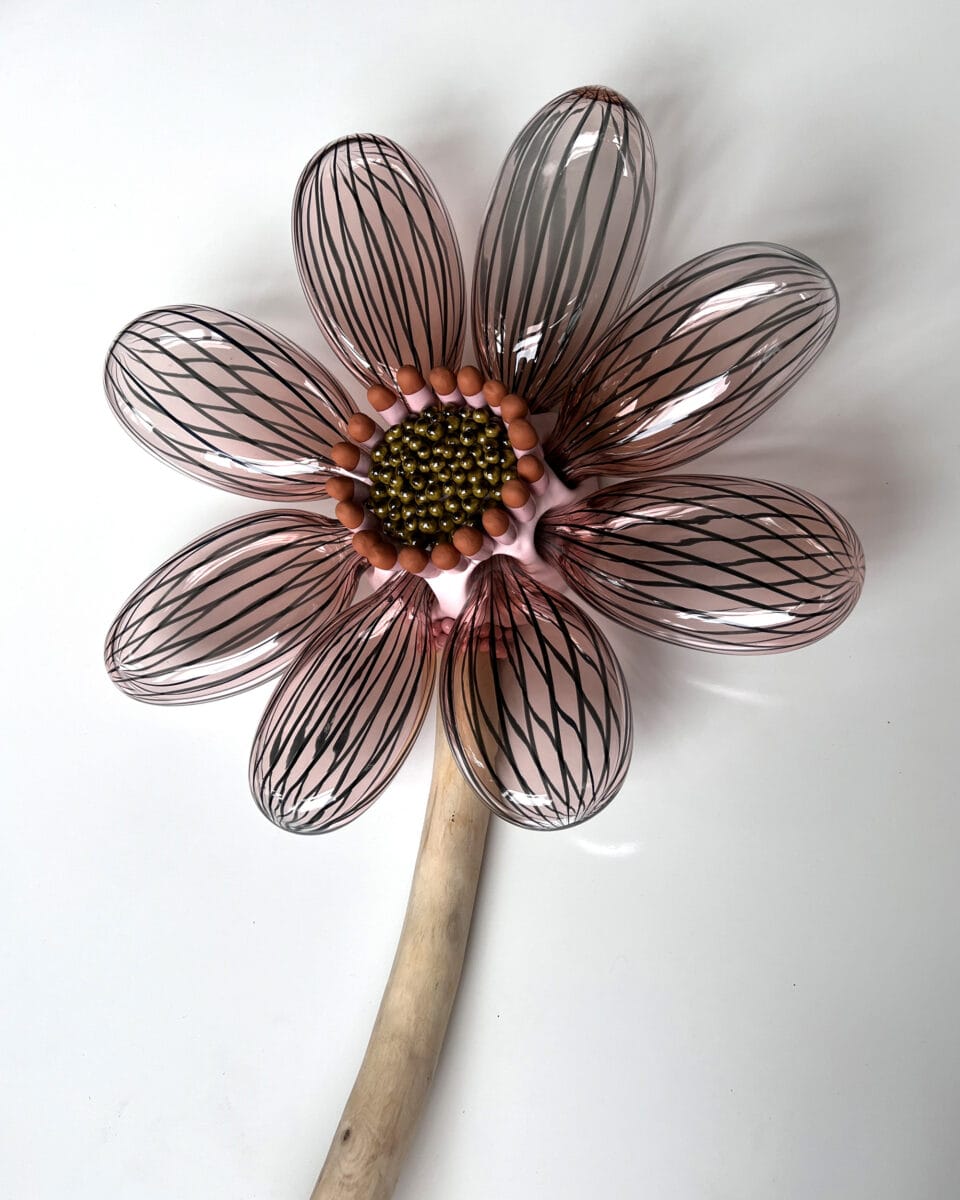 a botanical sculpture of a flower, made from glass, wood, and ceramics