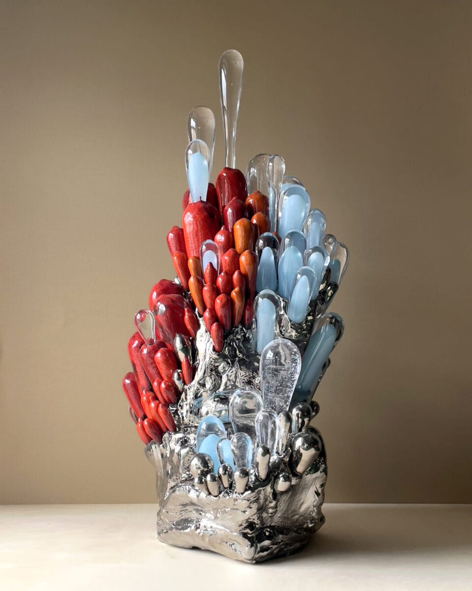 a sculpture of botanical form, made from glass, wood, and ceramics