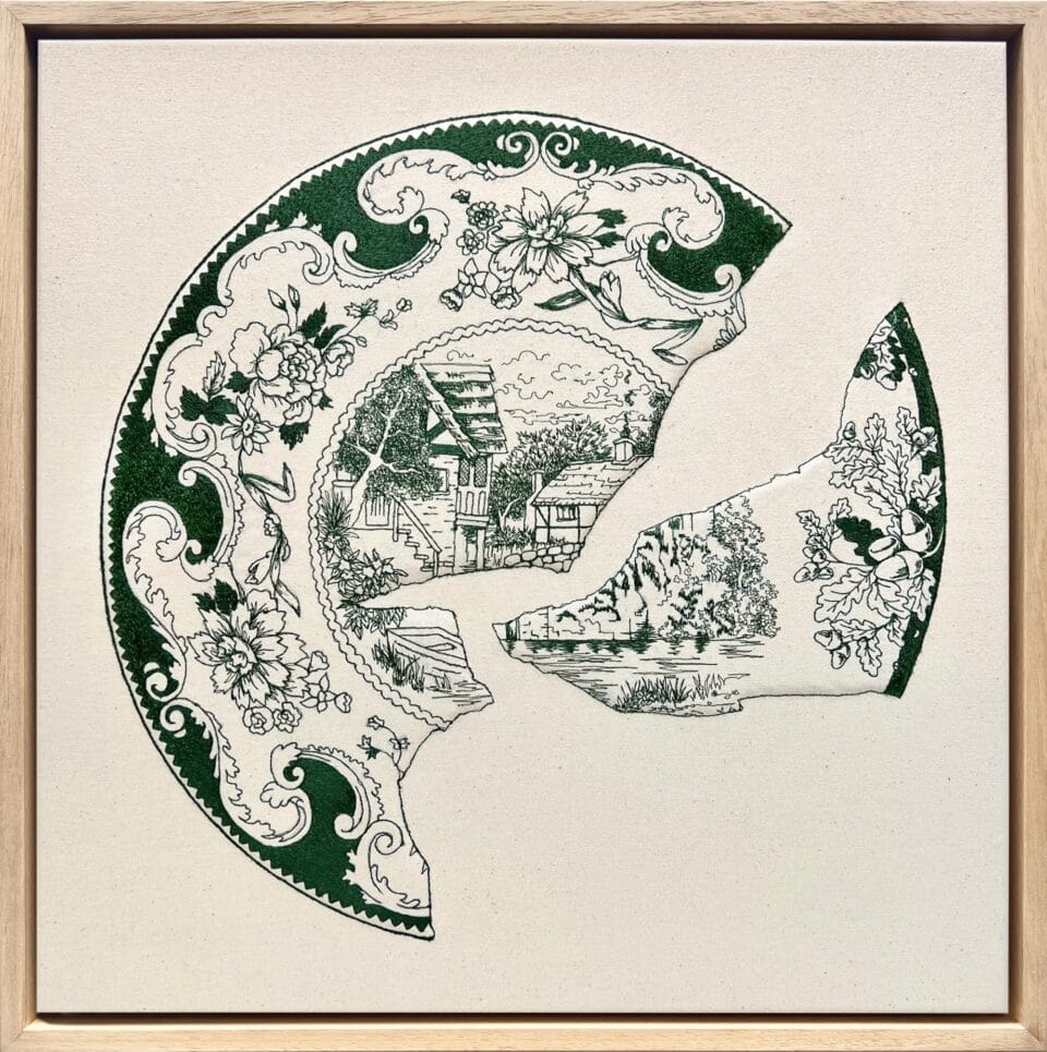 an embroidery of a green-and-white porcelain plate broken into pieces