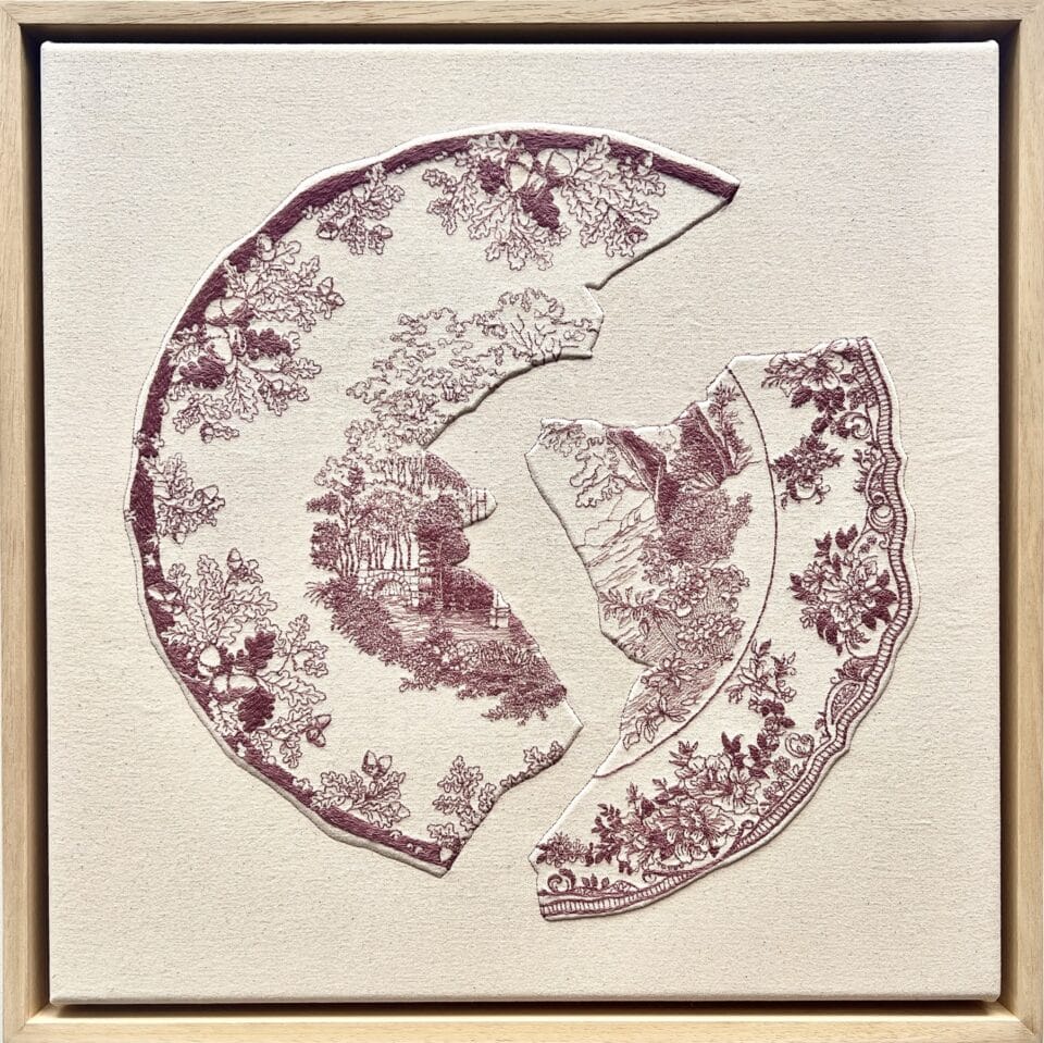 an embroidery of a red-and-white porcelain plate broken into pieces