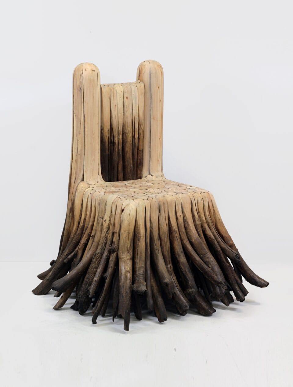 a sculptural chair that looks as though it has long fur or dreads, like a komondor or similar dog