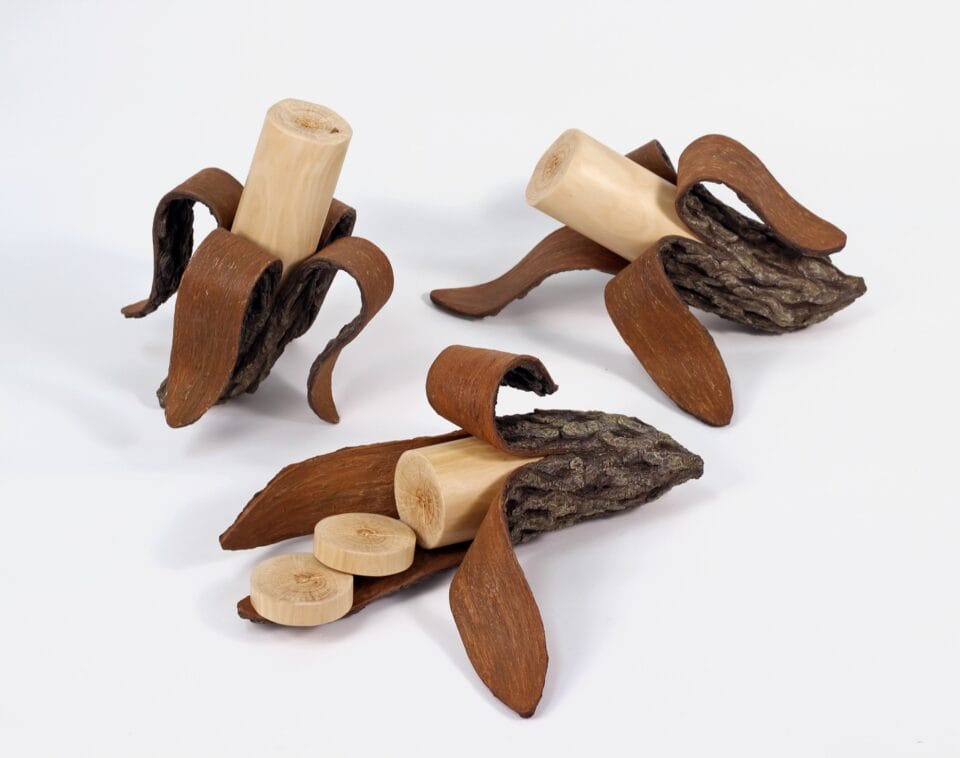 three wooden banana sculptures