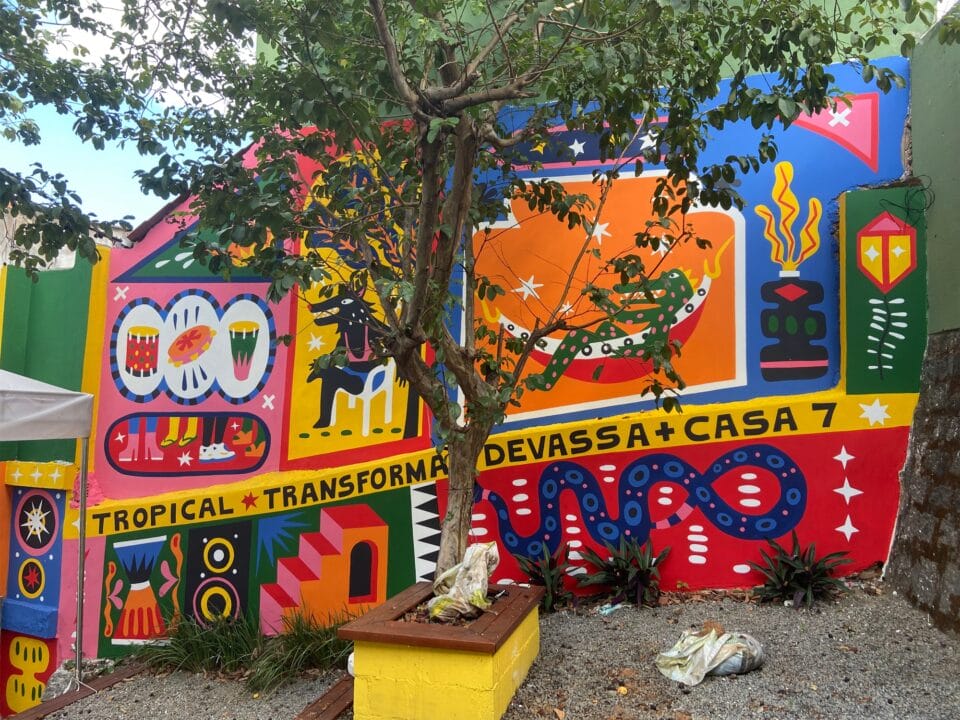 a brightly colored, geometric mural along a stepped walkway with a tree in the foreground