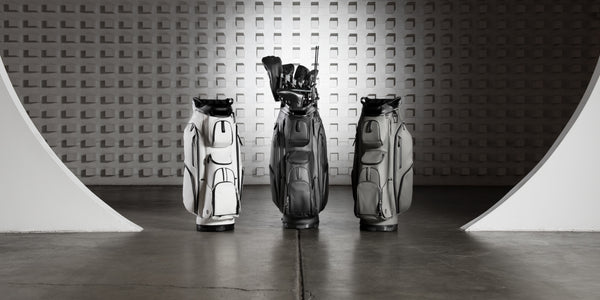 White, Black, and grey golf cart bags in large warehouse