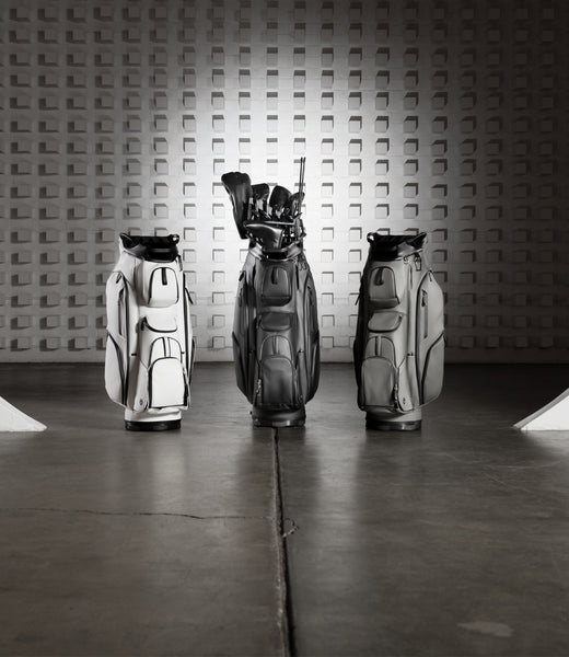 White, Black, and grey golf cart bags in large warehouse