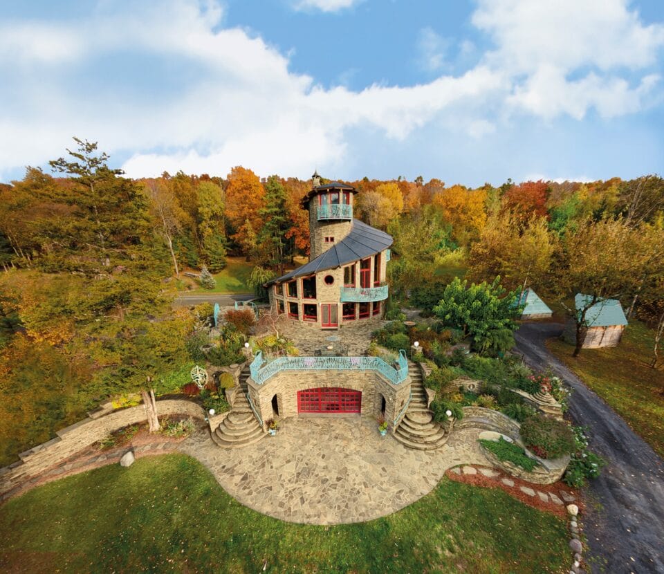 an architecturally eclectic house on a promontory, viewed from the air, designed in a spiral configuration