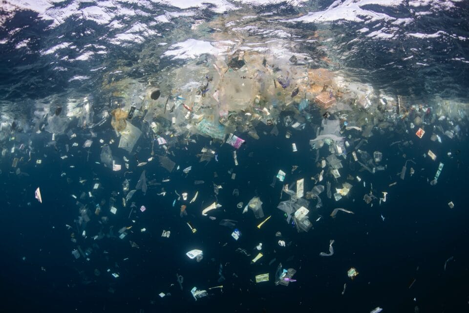 a bunch of trash being dropped into the ocean