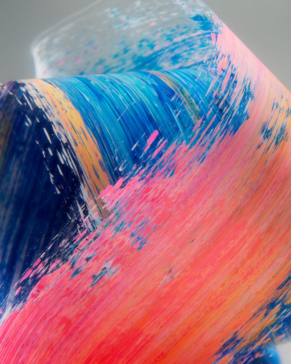 a detail of three-dimensional colorful brushstrokes captured inside clear resin