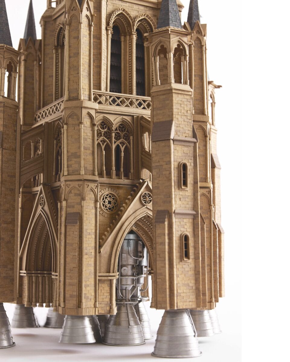 an elaborate cardboard sculpture of a gothic cathedral tower