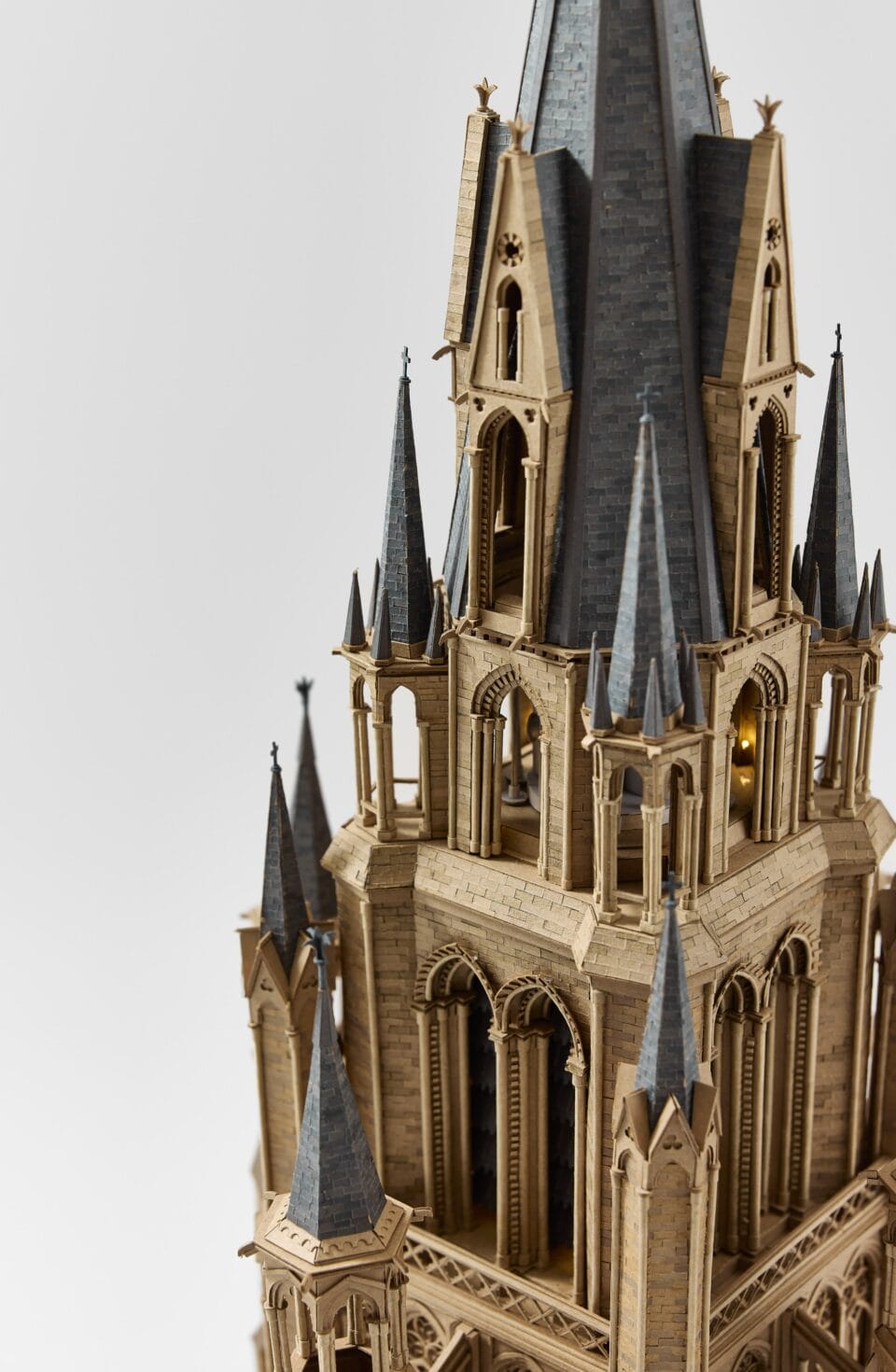 an elaborate cardboard sculpture of a gothic cathedral tower