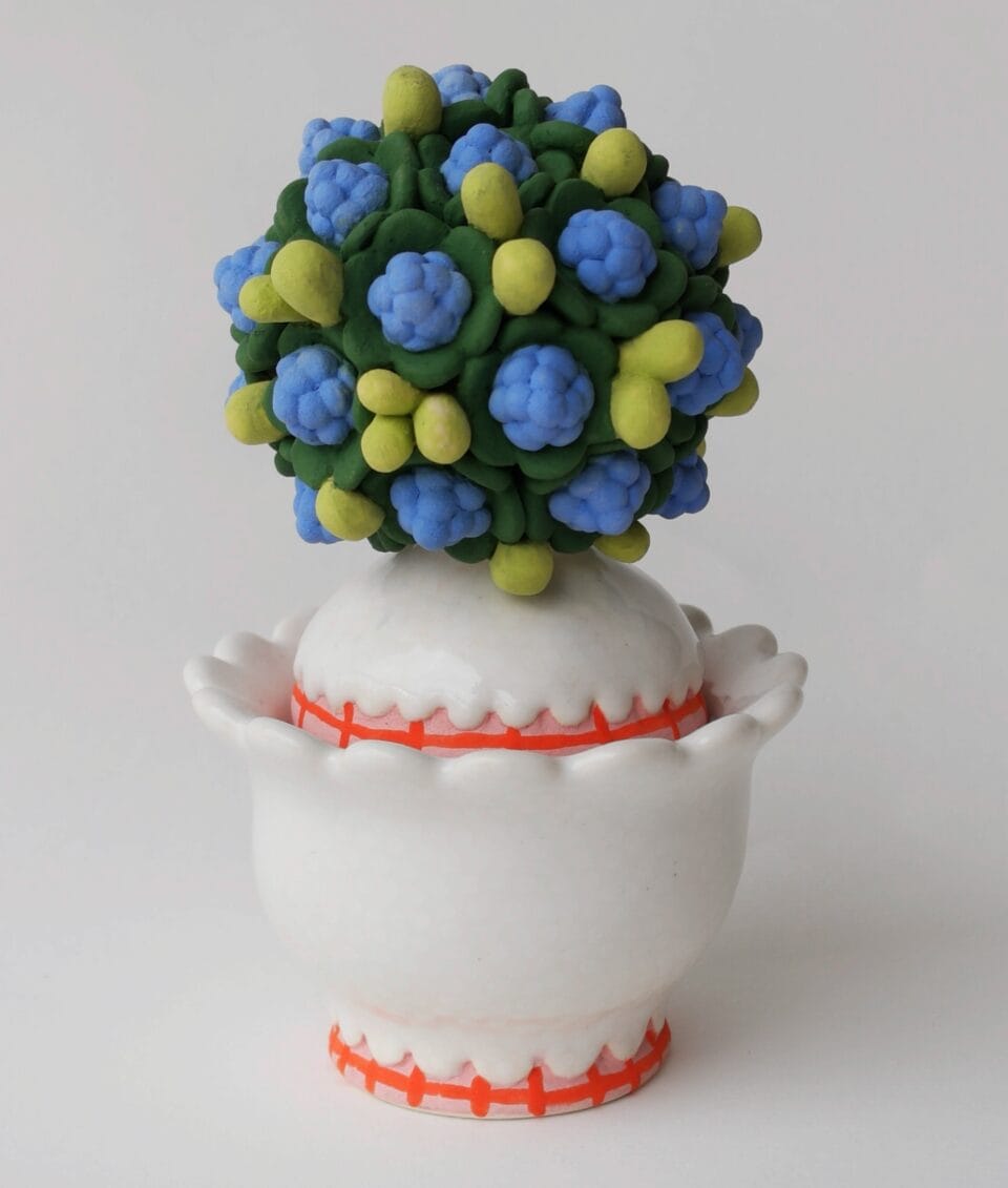 a confectionery-inspired ceramic vessel with a topiary-like top on the lid