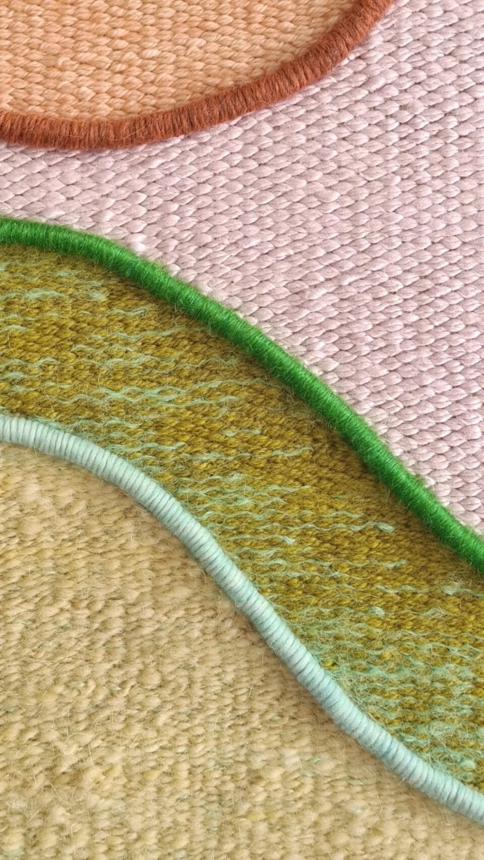 detail of a wall tapestry woven from vibrant fibers, incorporating geometric forms