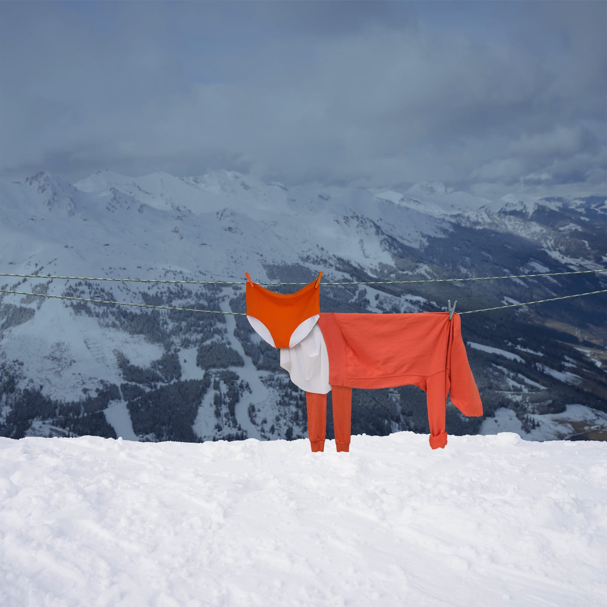 orange and white garments draped over a clothesline to look like a fox