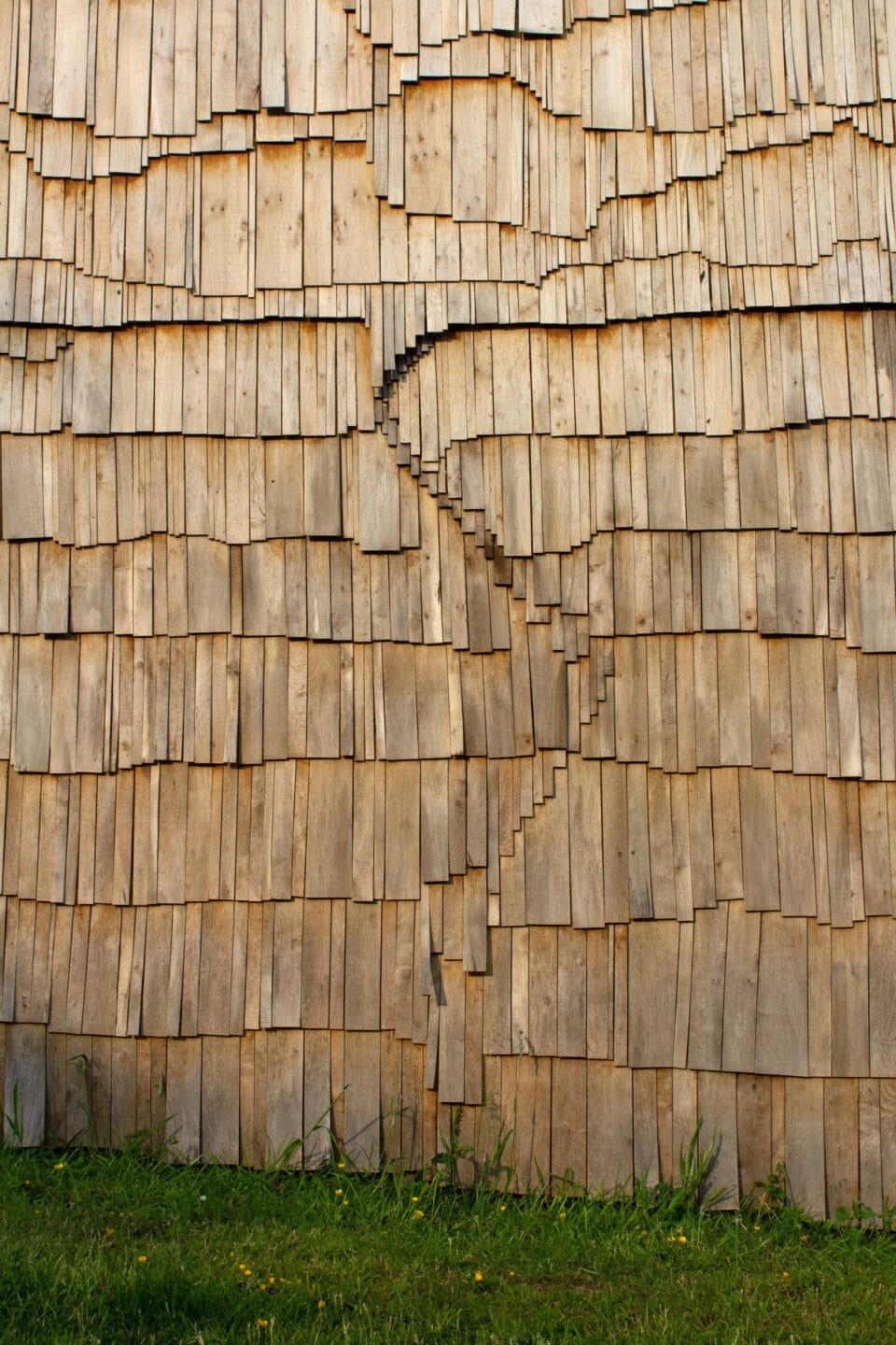 tiny wooden shingles in an undulating pattern