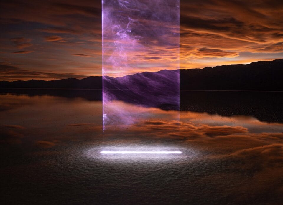 a photograph of a dusky sky over water in Death Valley, with a bright linear beam of light coming straight down from the sky and intersecting with the surface of the water