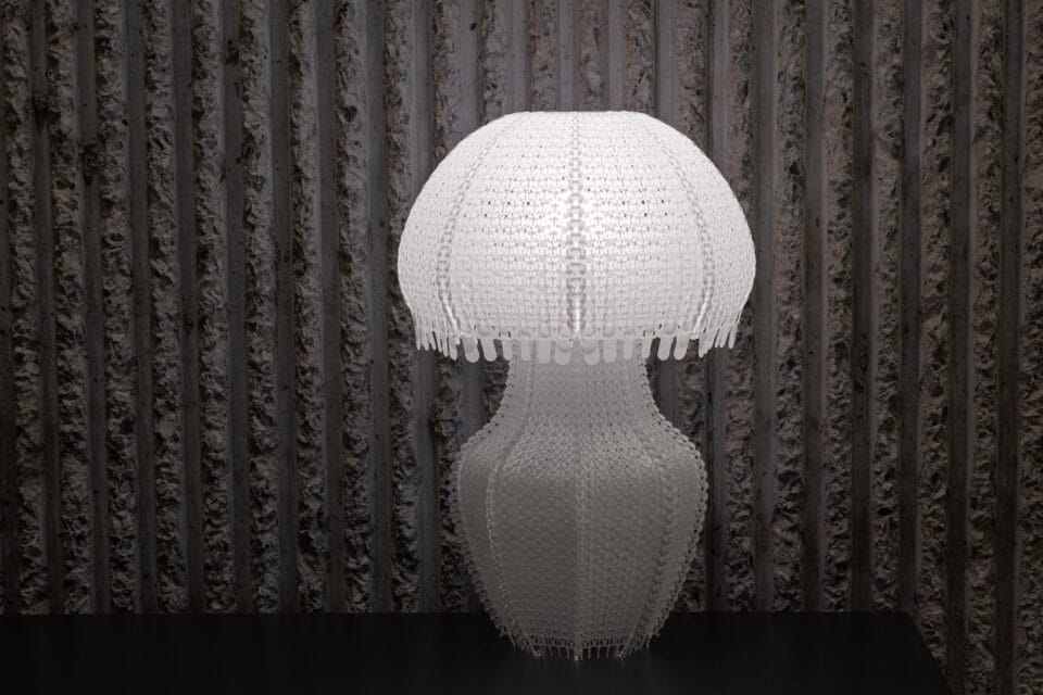 a white jellyfish-like lamp made of white knitted plastic